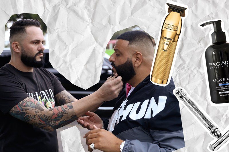 A barber grooming DJ Khaled's beard with a pair of clippers, some skin products, and a razor