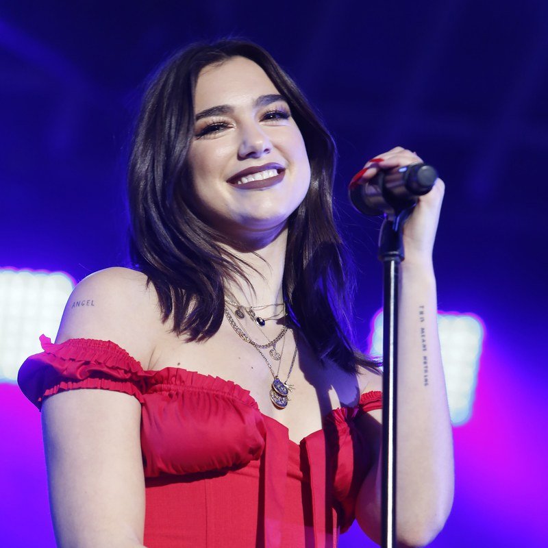 Dua Lipa in a red dress onstage