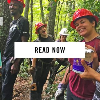 Read Now - a group of happy trail workers in the woods