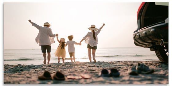 Couple walking with child on the beach