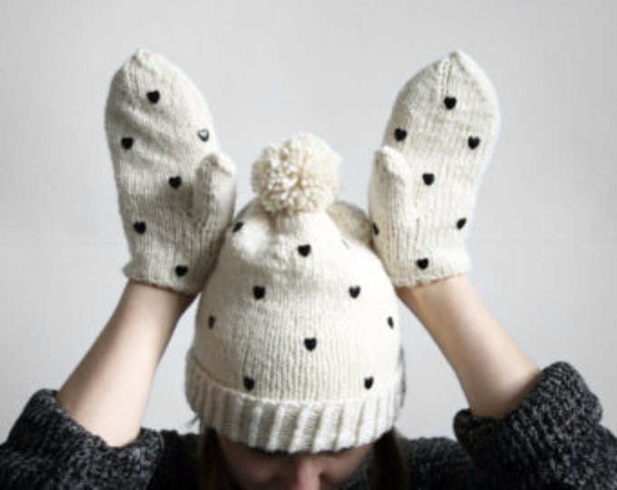 handmade cute natural white set of mittens and pom pom hat from wool with black heart shaped studs