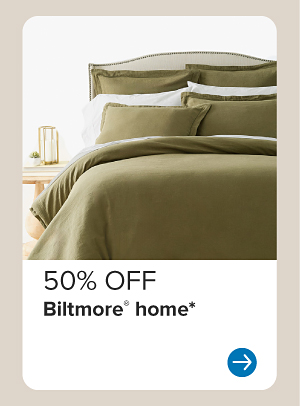 Image of a bed with green bedding. 50% off Biltmore home.