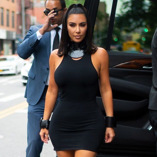 Kim Kardashian wearing a formfitting black mini dress