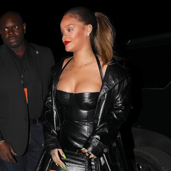 Rihanna pairs a ponytail with a red lip.