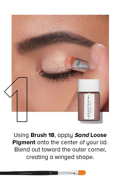 1. Using Brush 18, apply Sand Loose Pigment onto the center of your lid. Blend out toward the outer corner, creating a winged shape.