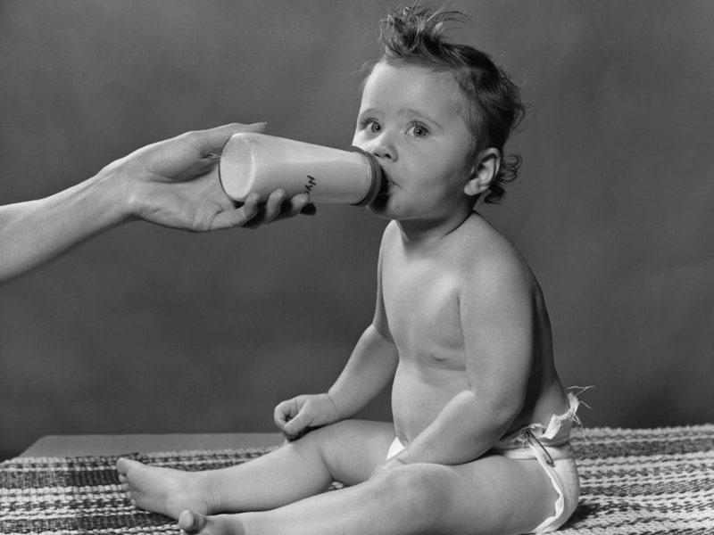 Image may contain: Body Part, Finger, Hand, Person, Face, Head, Photography, Portrait, Bottle, Shaker, and Baby