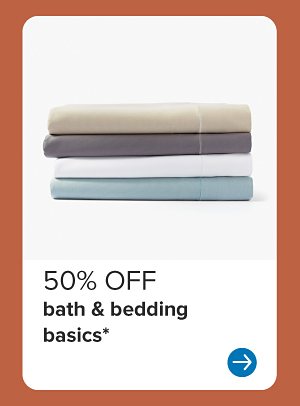 A stack of folded sheets. 50% off bath and bedding basics.