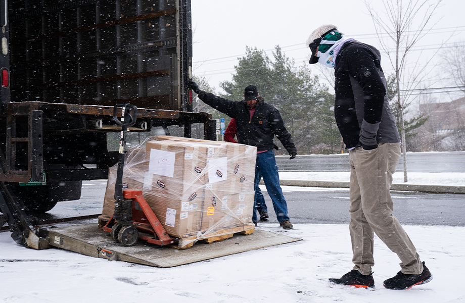 A pallet of warm, toasty Darn Tough socks is unloaded from a truck during a typical April shower in Vermont... the snowy kind.