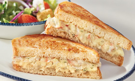  NEW! Crab Melt Sandwich, halved and stacked on a plate. 