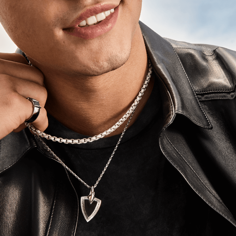 A man poses, showcasing Bold Diamond Chains & Necklaces.