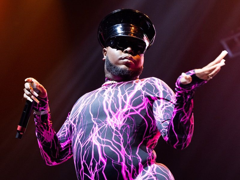 Image may contain: Helmet, Clothing, Apparel, Human, Person, Electrical Device, Microphone, Stage, and Dance Pose