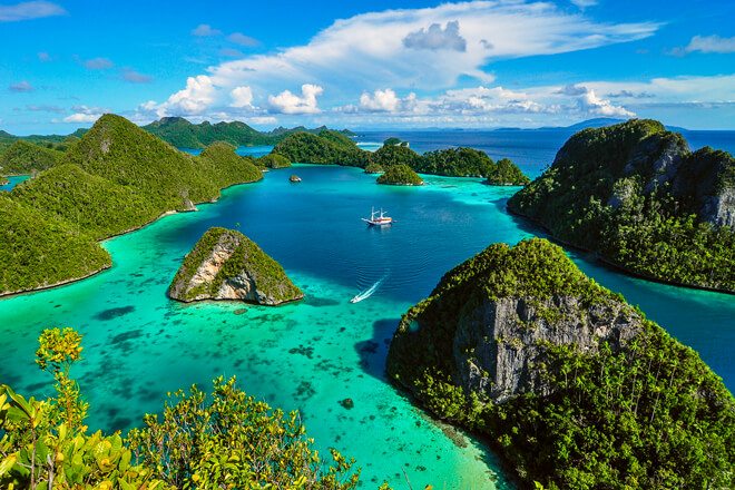 Sail through turquoise waters and the lush Raja Ampat Islands in West Papua.