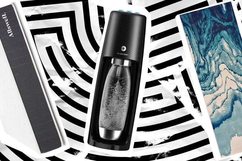 A mattress, a sodastream, and a blanket on a patterned background