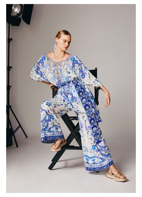 Model wearing jumpsuit layered with kaftan over the top