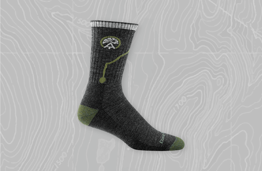 ATC Micro Crew Cushion Sock imposed over a gray topographic trail map