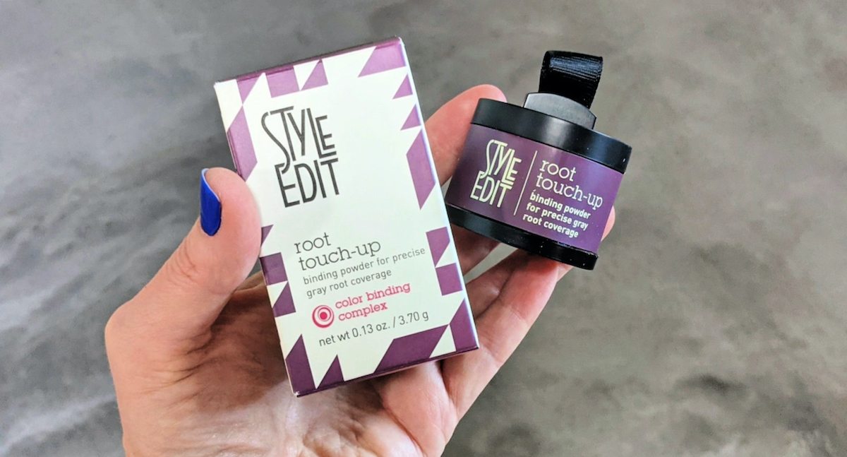 hand holding a box and container of style edit root touch up