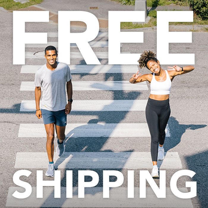 Two runners, all smiles crossing the street in Darn Tough socks for free shipping