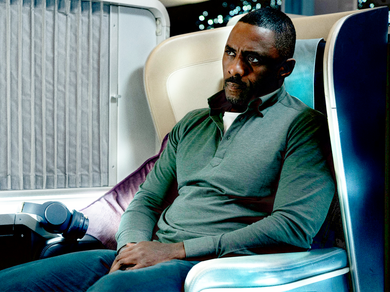 Image may contain: Idris Elba, Cushion, Home Decor, Person, Sitting, Adult, Head, Face, Photography, and Portrait