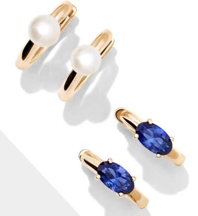 Image of two gold hoops, one with a pearl in the center, the other sapphires in the center