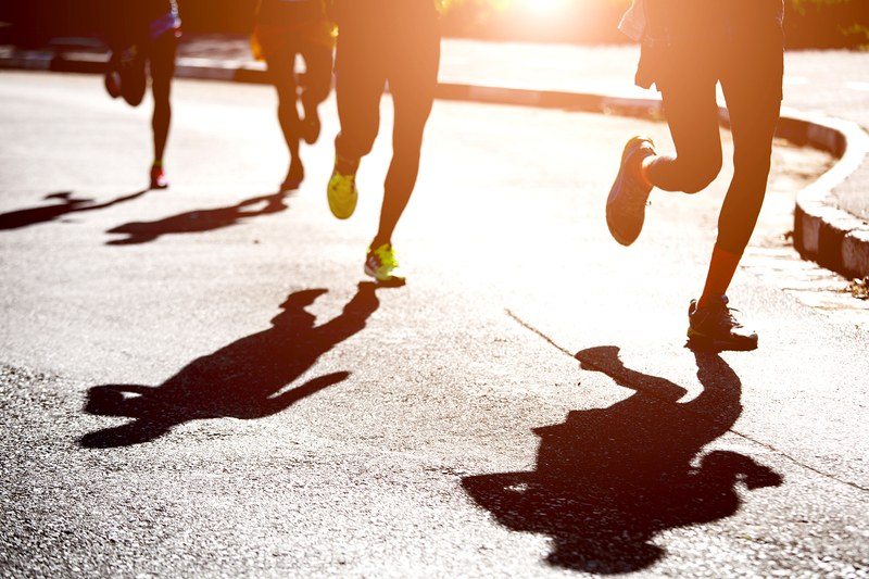 Shadows of runners on the road