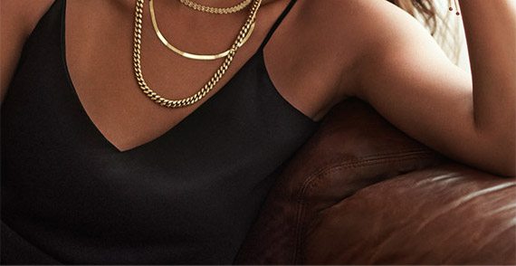 Happy woman wearing gold jewelry