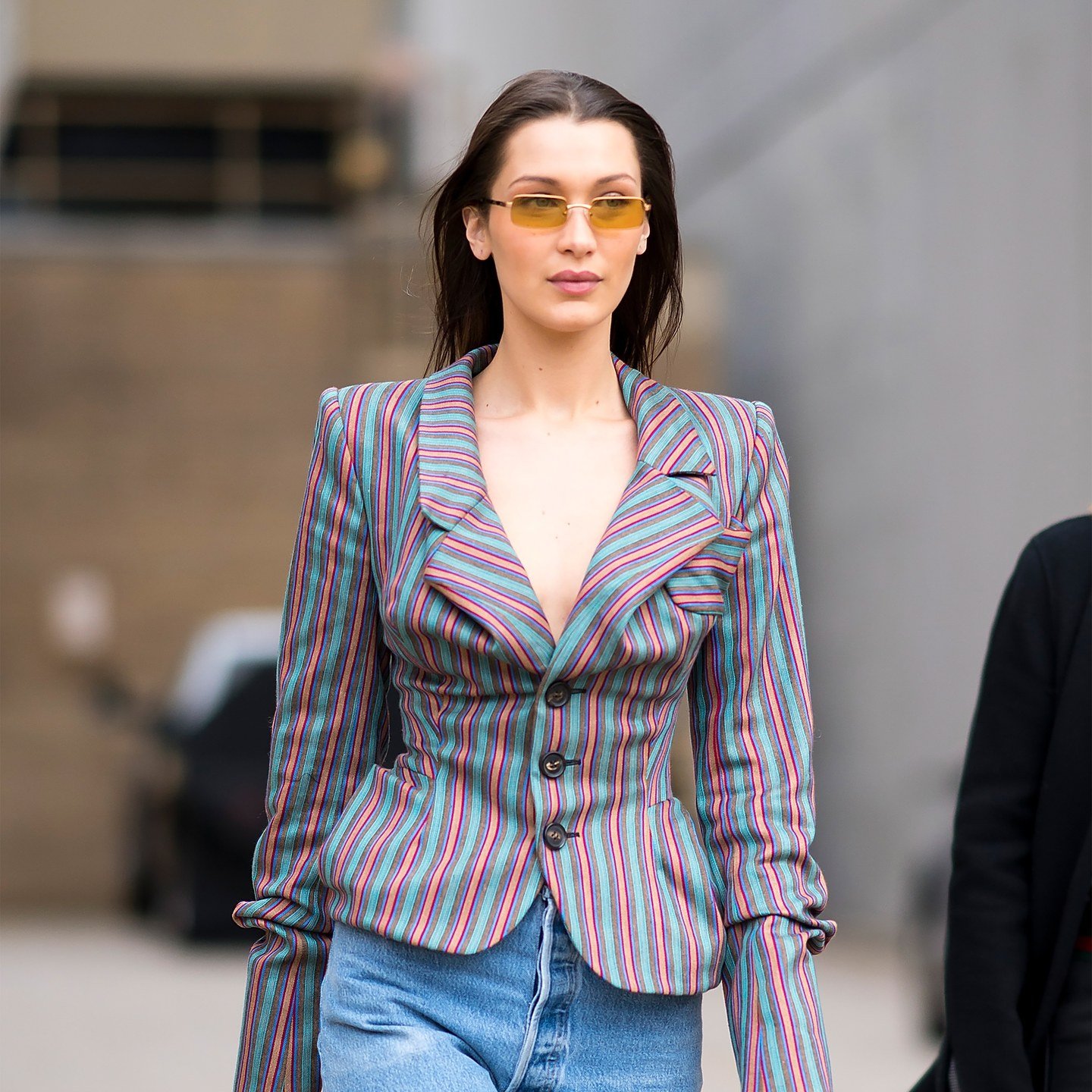 Bella Hadid pairs a middle-part with orange lenses.