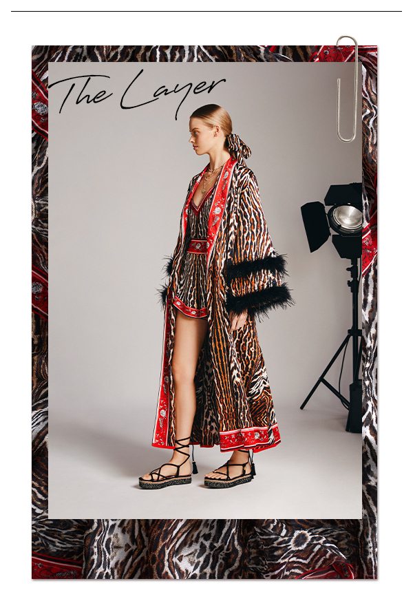 The Layer | Leopard robe with red border detailing and feather cuffs.