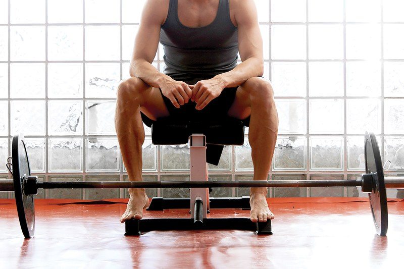 Man sitting with weights in gym