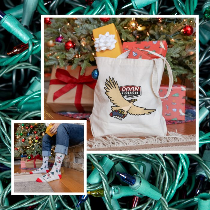 Shop with Free Shipping - a Darn Tough falcon tote bag stuffed with gifts in front of a tree