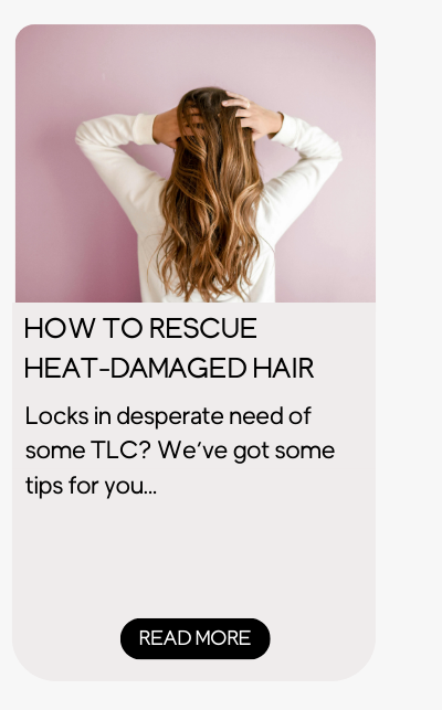 Woman running hands through her healthy hair after learning how to repair it.