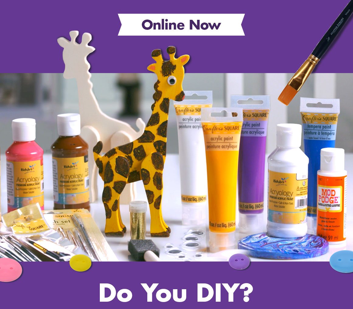 Paint, brushes, and a wooden paintable giraffe on a table