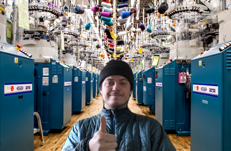 Delighted fellow in a beanie giving a thumbs up in front of his snazzy new Zoom background featuring our Mill's machinery