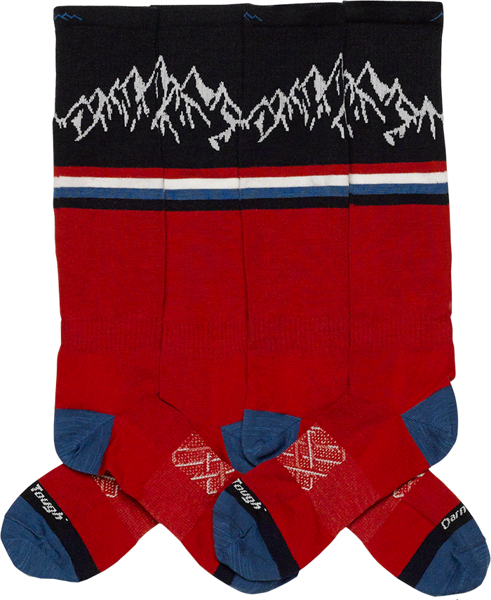 Four Alpen Glow Ski/Ride socks laid down to show off the mountain design on the leg.