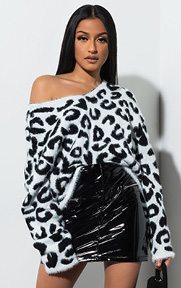 Paws Off Fuzzy Leopard Print Sweater is made from a fuzzy soft knit fabrication with an all-over white and black snow leopard print, a v neckline, relaxed sleeves, and a relaxed A-line fit.