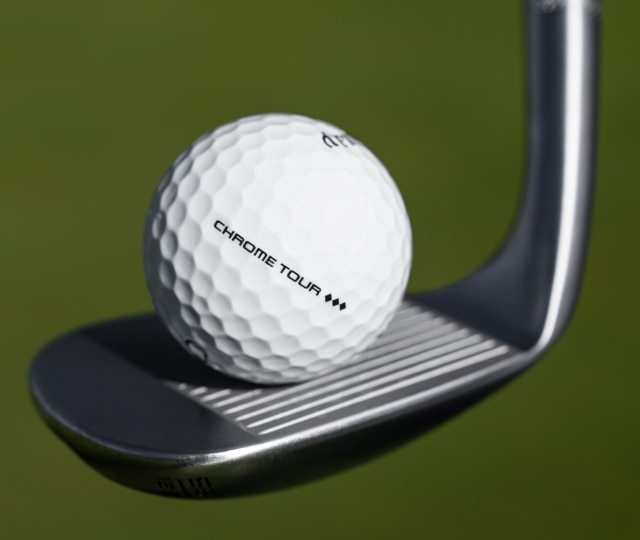 Johnny Wunder Standing In Front of Elyte Fairway Wood Club Heads