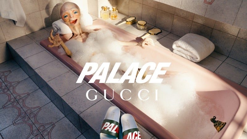 An alien creature in a pink bathtub overlaid with Palace Gucci logo, a pair of Palace Gucci slide sandals in the foreground
