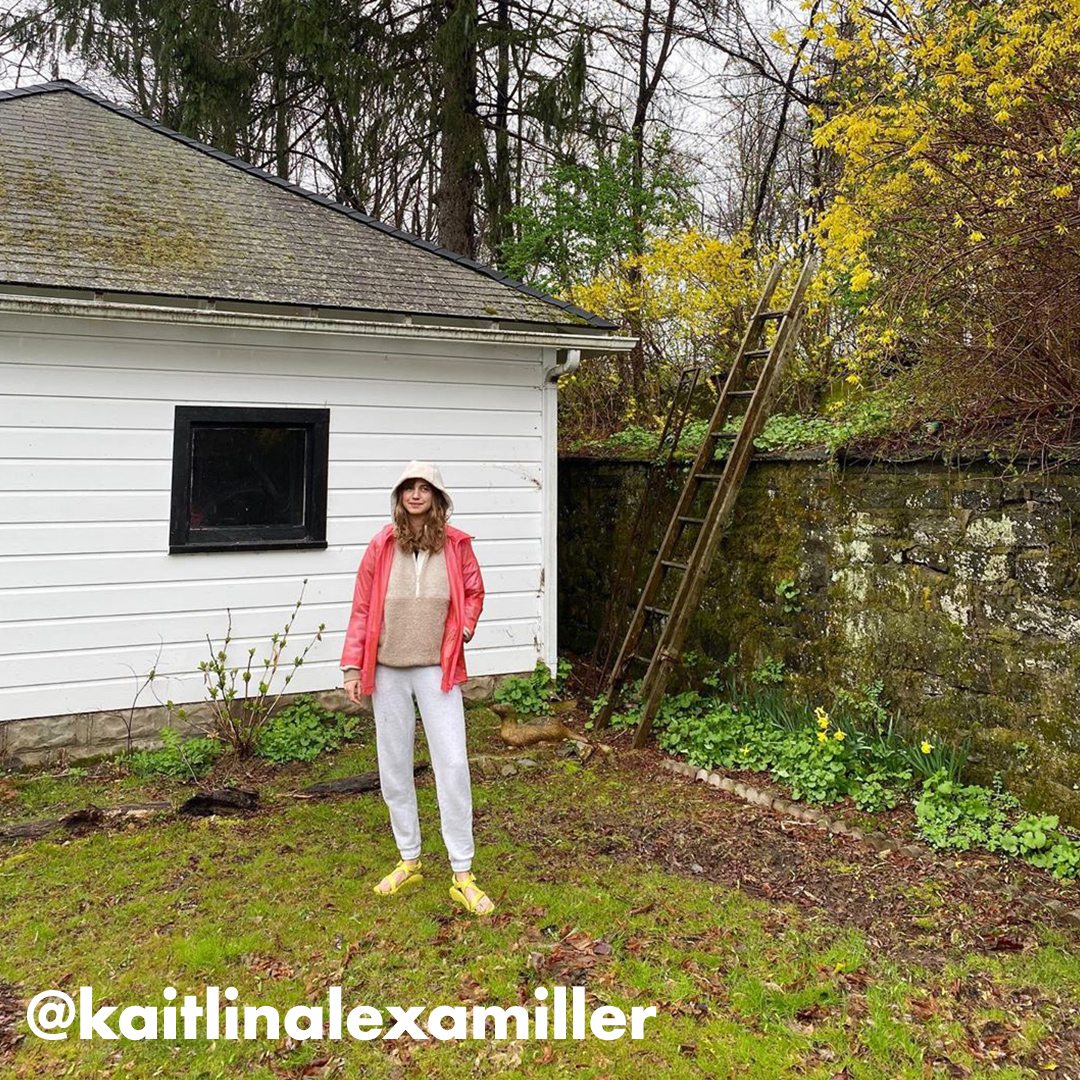 Sandals model outside in a yard with greenery, social tag: @kaitlinalexamiller