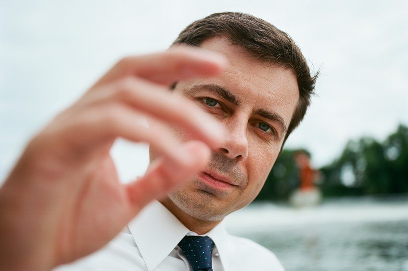 pete buttigieg puts his hand in front of the camera