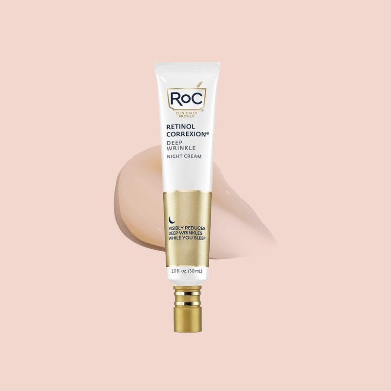 A white and gold tube of RoC Retinol Correxion Deep Wrinkle Night Cream on pale pink background