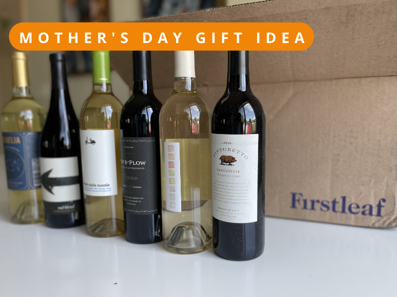 6 bottles of wine from First Leaf on display on a white table with the shipping box labeled First Leaf behind them