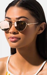 The QUAY Elle Fold Up Sunglasses provide minimalist aesthetics with their sleek metal frame and curved brow bar.