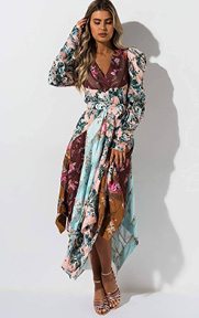 The AKIRA Label Perspective Floral Color Block Maxi Dress is a sheer, satin based dress complete with long ruched sleeves, a wrap front neckline, floral pattern blocked design, concealed back zipper and vintage inspired maxi length and a matching tie belt.