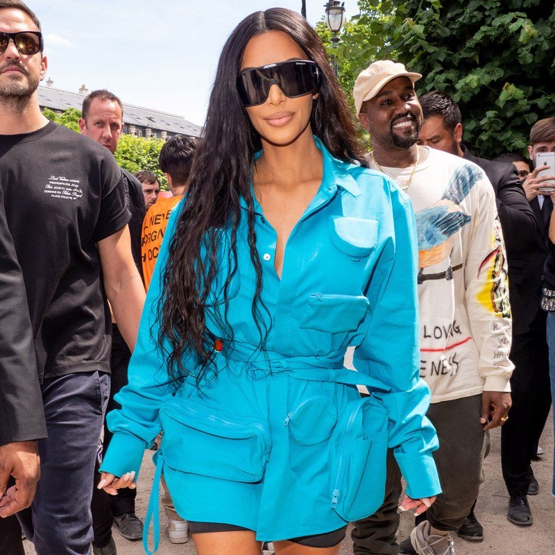 Kim Kardashian West pairs long waves with black sunglasses.