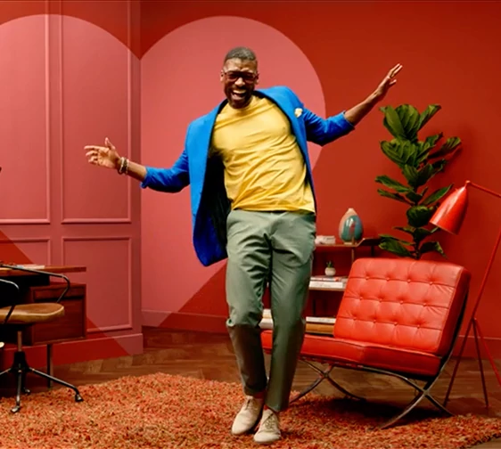 A man dancing in his newly painted living area