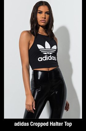 The adidas Cropped Halter Top is made from a stretch cotton fabrication with a high neckline, halter straps, an open back, cropped length, and a large adidas trefoil logo across the front.