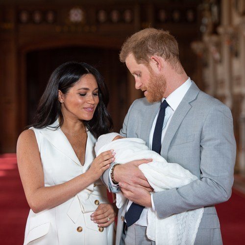 Prince Harry, Duke of Sussex and Meghan, Duchess of Sussex, pose with their newborn son Archie Harrison Mountbatten-Windsor during a photocall in St George's Hall at Windsor Castle on May 8, 2019 in Windsor, England.