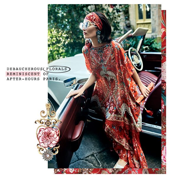 Model in red printed kaftan and headband getting out of car.