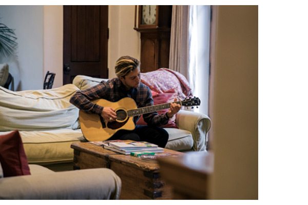 Conner enjoying his guitar in the Dixon Flannel