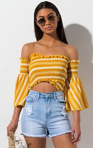 Spring Into Love Crop Top is an all over ruched, striped, summer-ready blouse complete with flowy, bell sleeves, an off the shoulder neckline and super cropped hem.