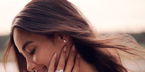 Smiling woman wearing a Neil Lane diamond engagement ring